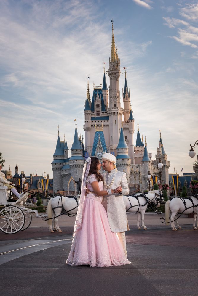 Photo of Bride and groom post in front of castle at Disney World, Orlando
