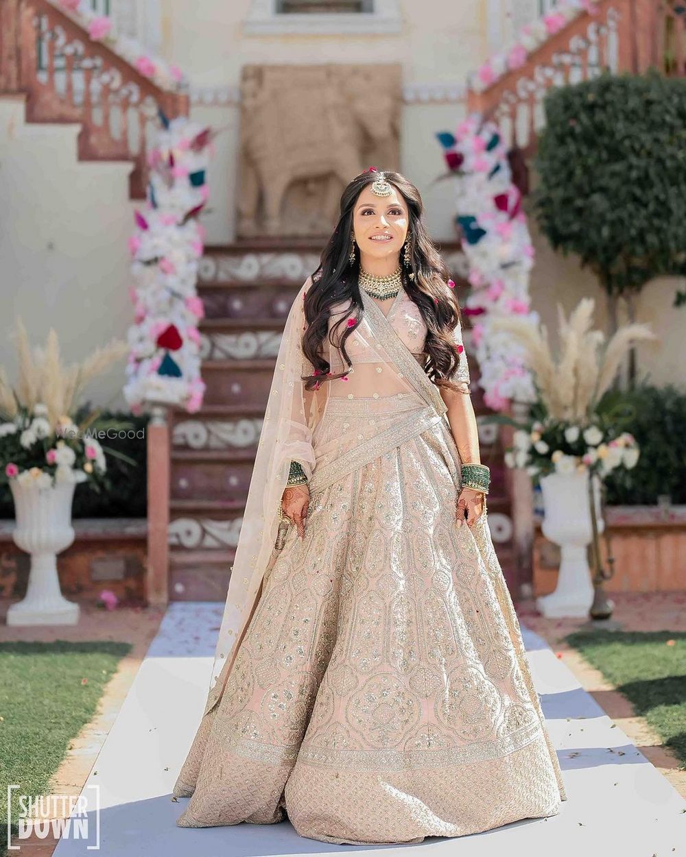 Photo of blush pink sabyasachi bridal lehenga with open hairstyle