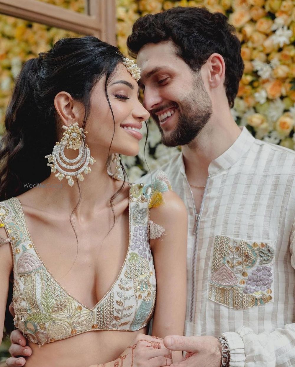 Photo of Alanna & Ivor in pastel outfits on their haldi