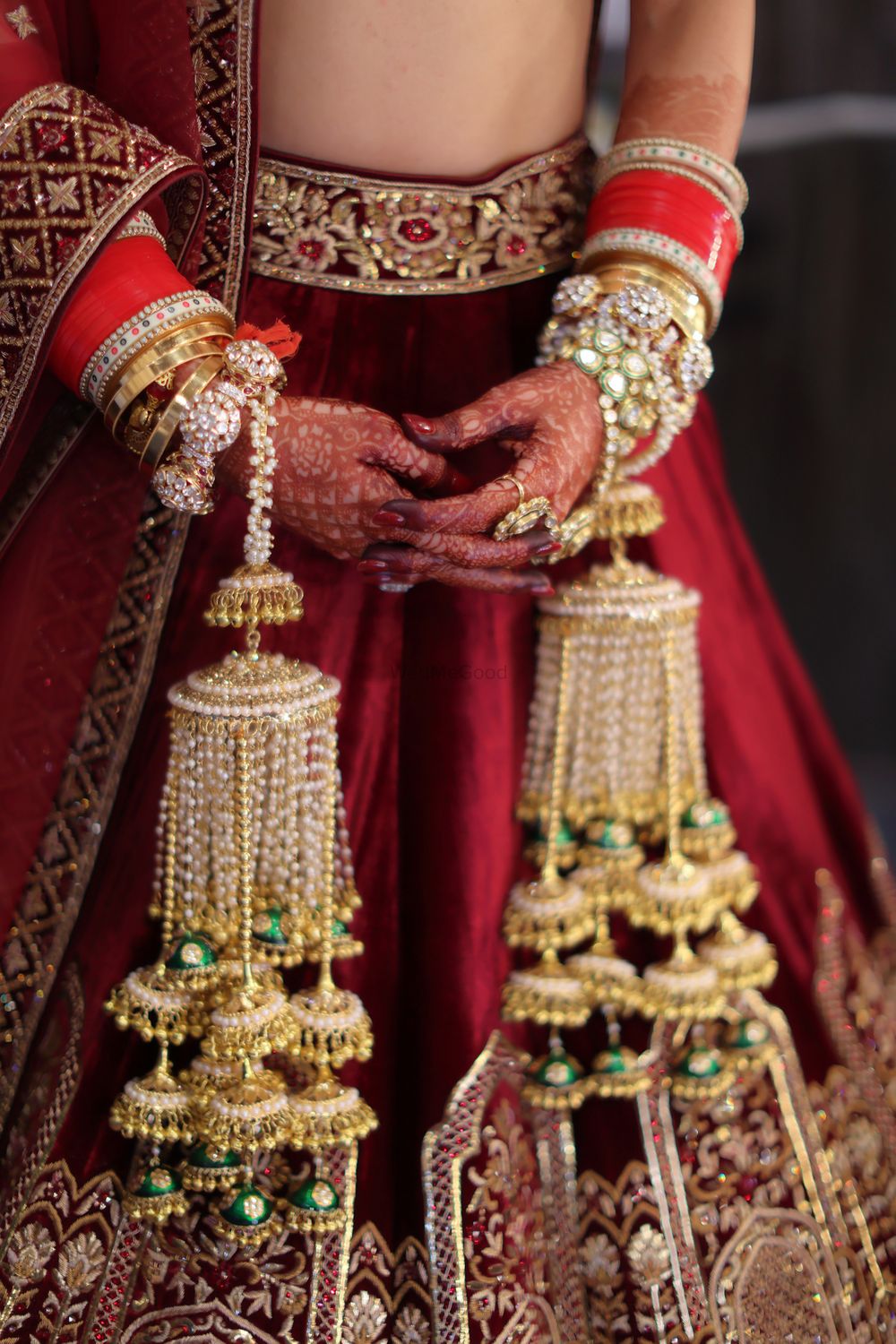 Photo of Gold bridal kaleeras perfectly matching the red and maroon bridal lehenga