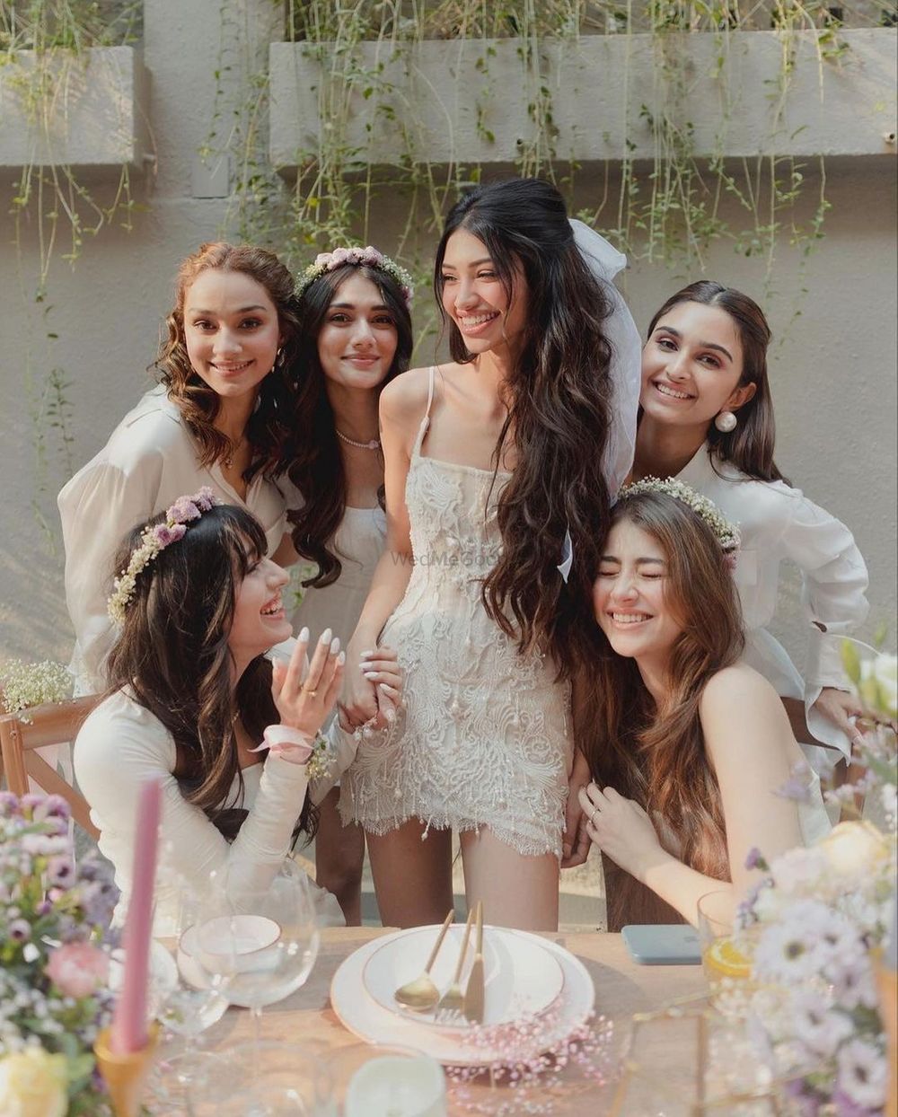 Photo of Alanna with her bridesmaids in white outfits.