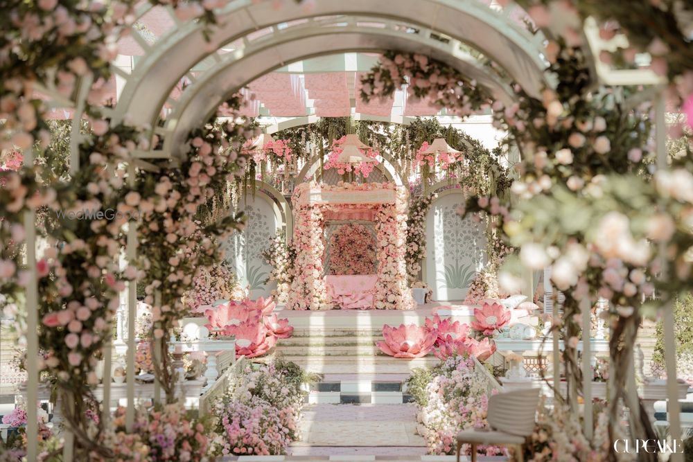 Photo of Gorgeous floral mandap in pastel theme with an arch-style entrance tunnel with lotus decor
