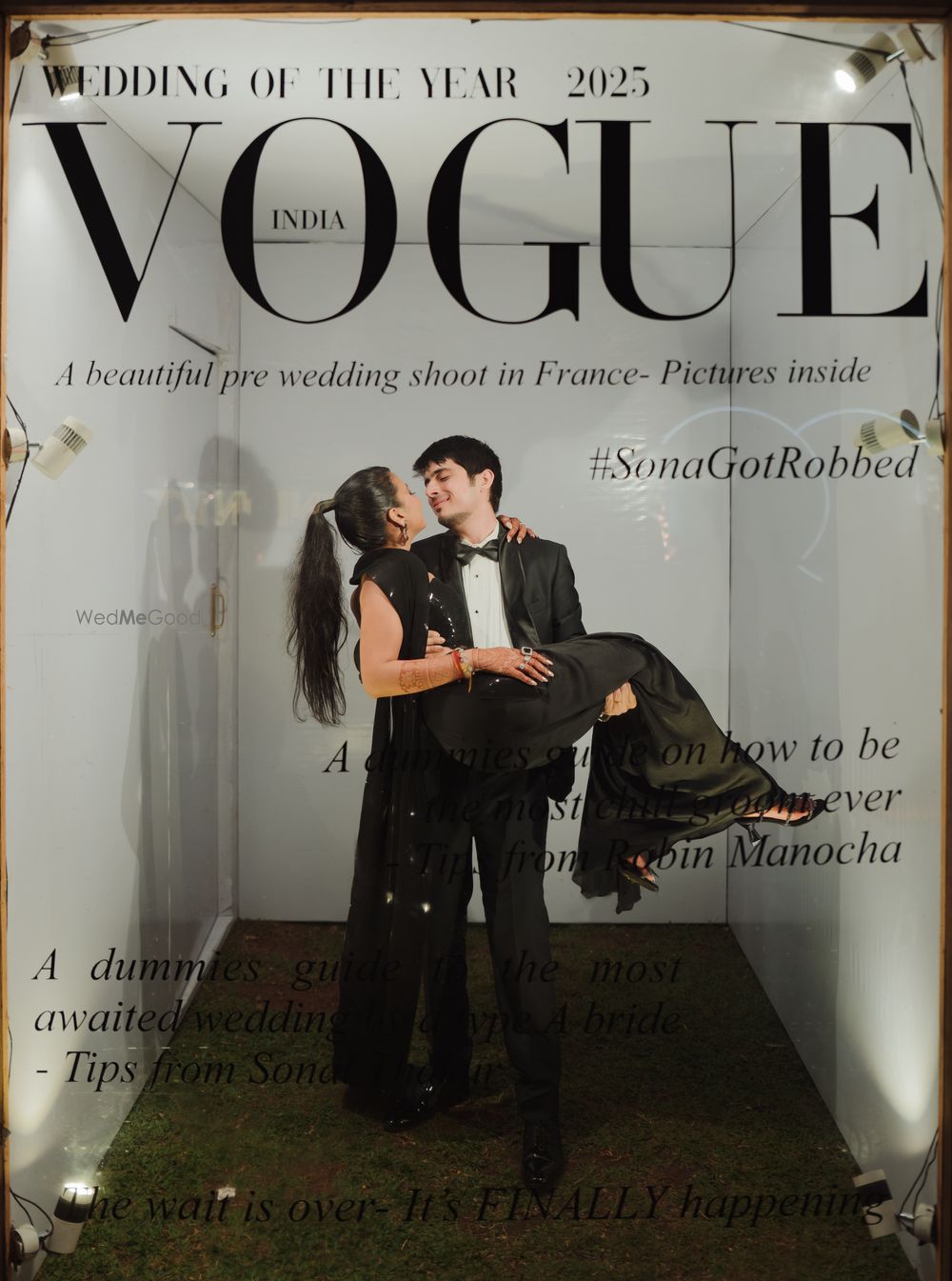 Photo of The classic Vogue magazine cover photobooth for the sangeet night with the groom carrying the bride