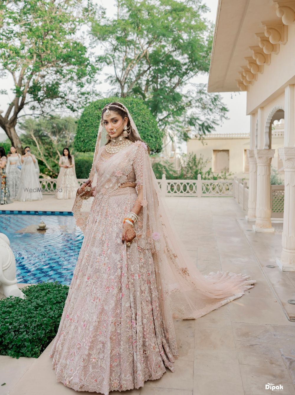 Photo of Classic outdoor bridal portrait in a pastel bridal lehenga