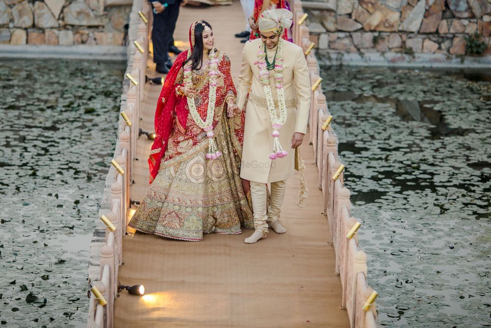 Photo of Bride and groom walking hand in hand.