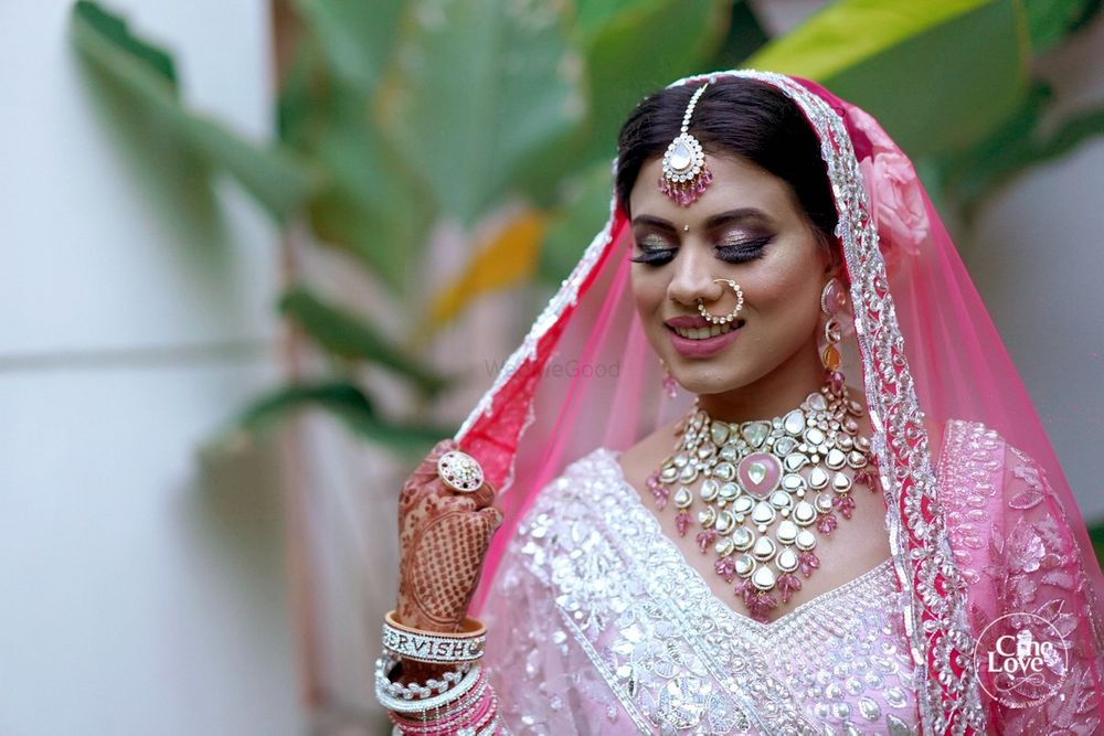 Photo of Bride wearing pink lehenga and jewellery