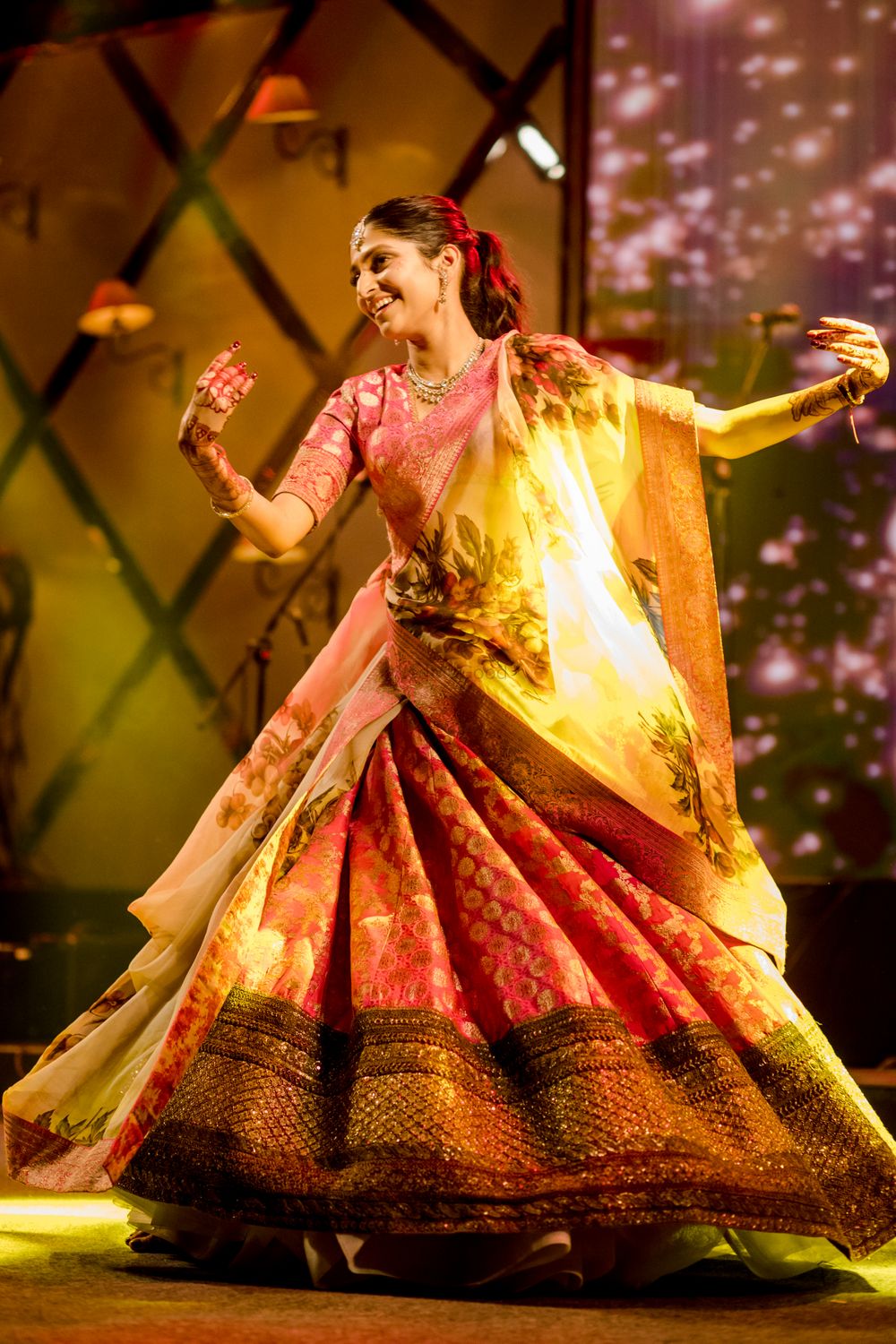 Photo of Bride dancing at her sangeet ceremony.
