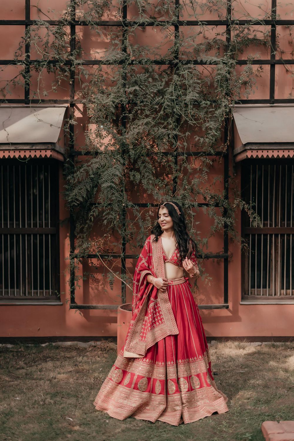 Photo of Bride in a red Sabyasachi lehenga for the wedding.