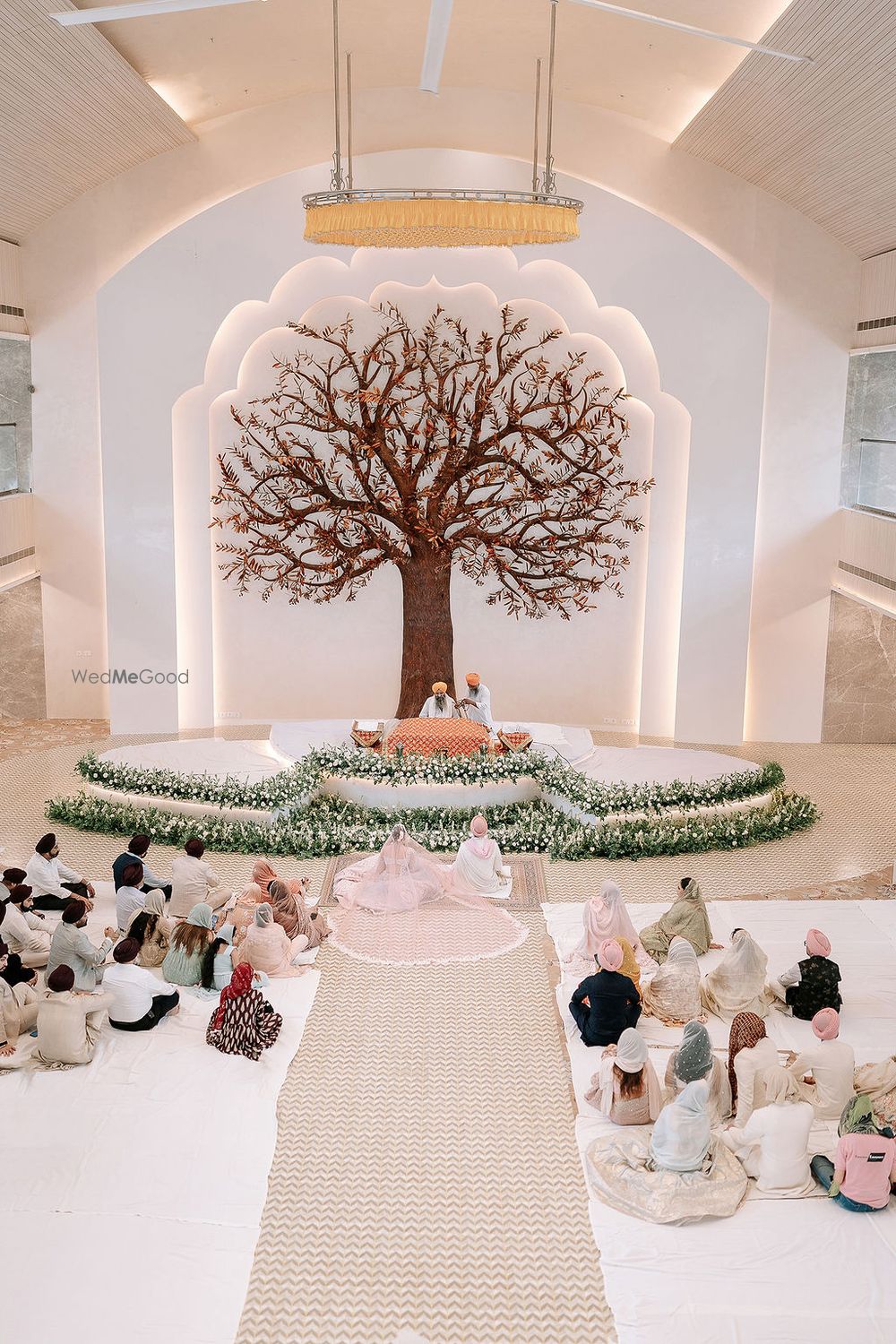 Photo of Super stunning tree of life mandap and wedding stage with floral decor