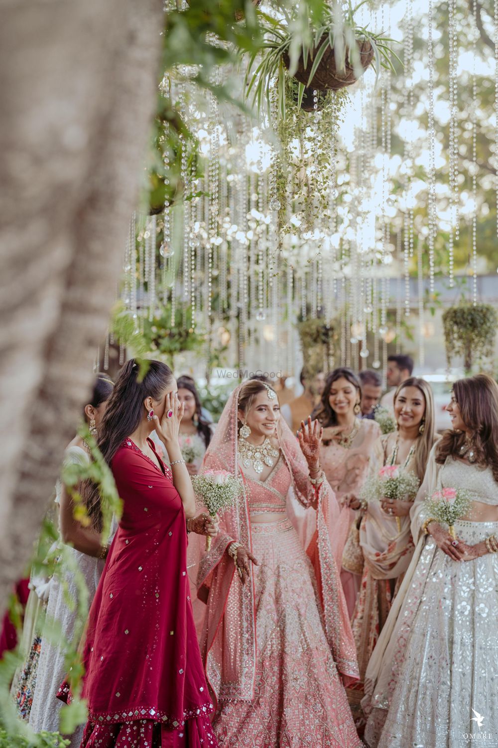 Photo of bride and her bridesmaids first look photos