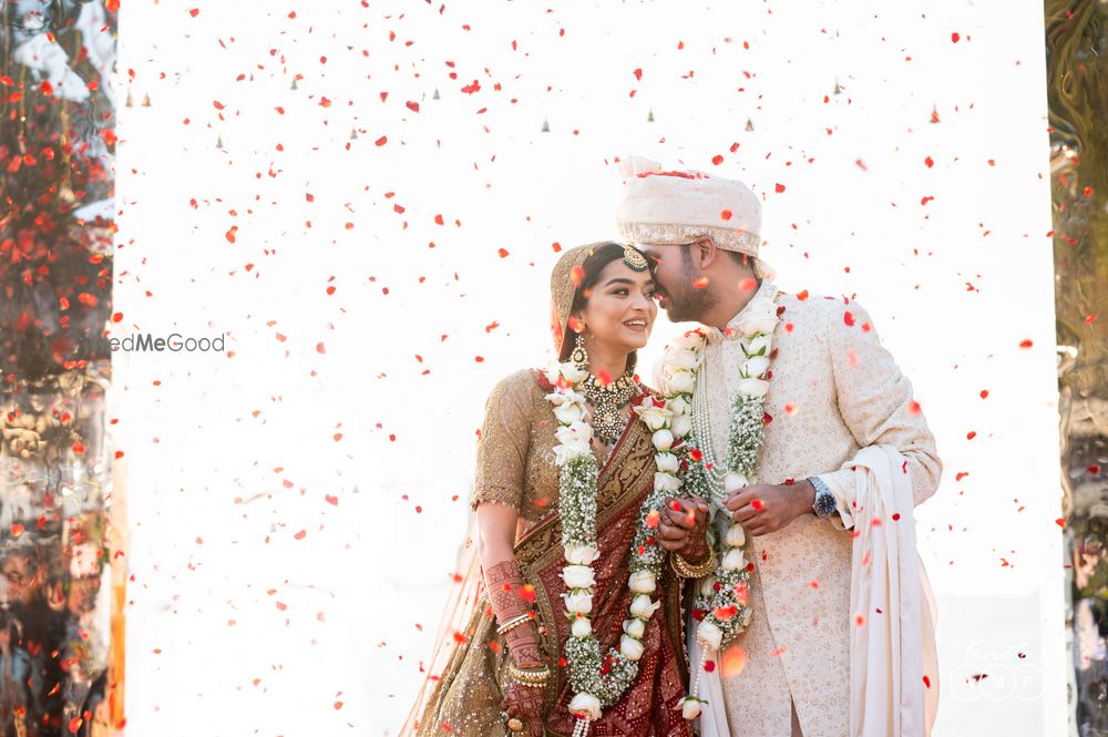 Photo of Cute bride and groom portrait under rose shower after jaimala