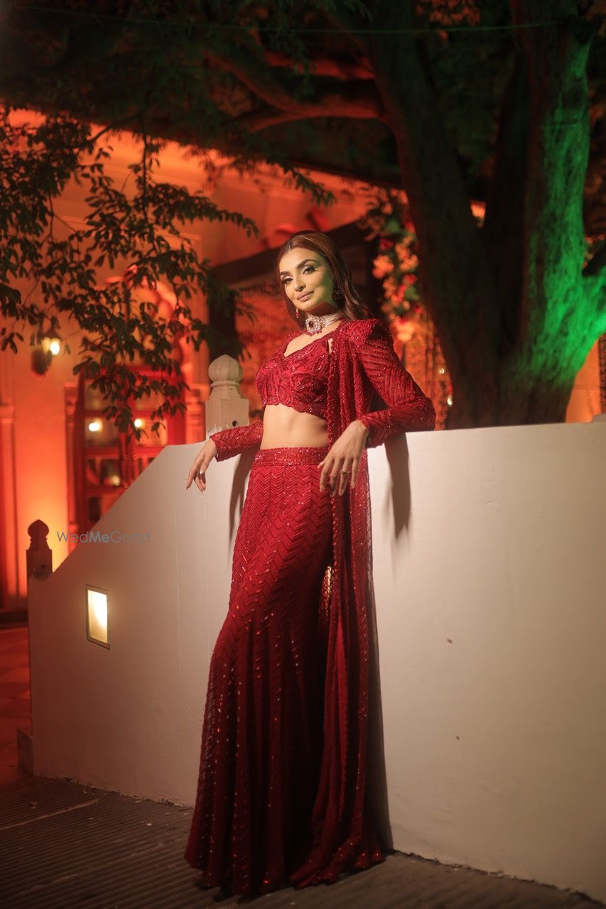 Photo of An all-red indo western outfit with a cape and diamond and ruby choker for the sangeet night