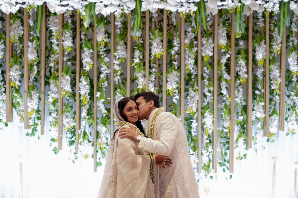 Photo of Lovely floral decor for the mandap backdrop with hanging decor elements