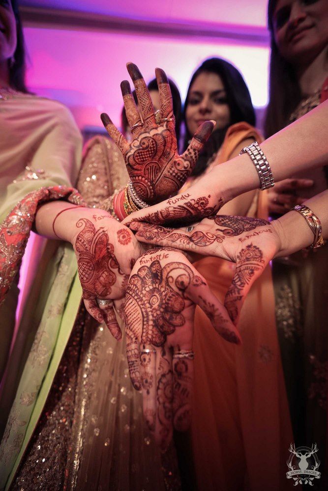 Photo of Fun Bridesmaids Photo with Words in Mehendi