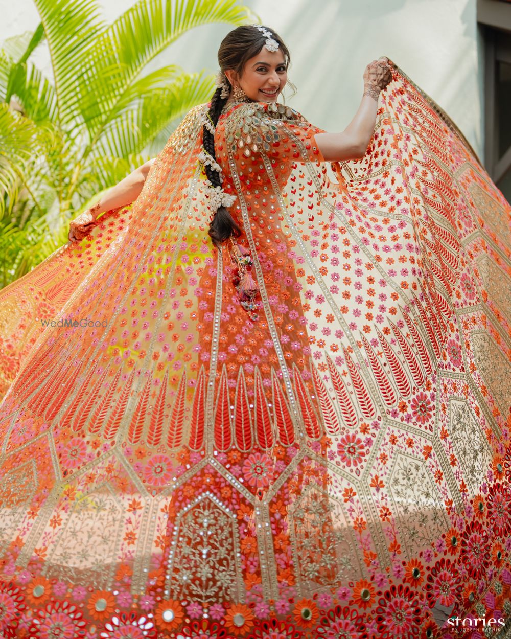 Photo of Stunning shot of an orange and pink phulkari cape ensemble for the mehendi event