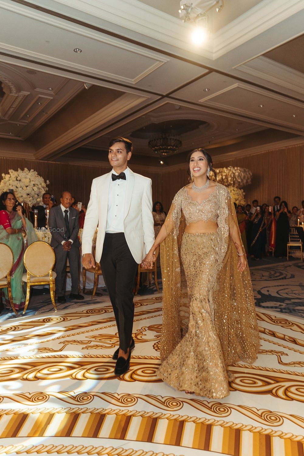 Photo of Mermaid style gold gown with cape style dupatta for bride on sangeet night