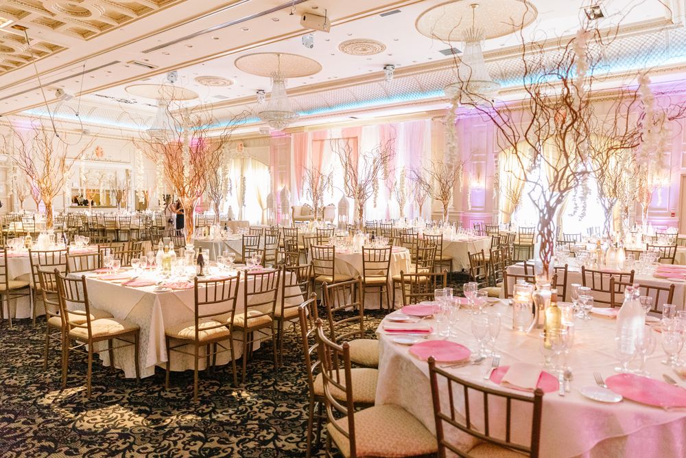 Photo of Unique table setting in light pink theme for reception