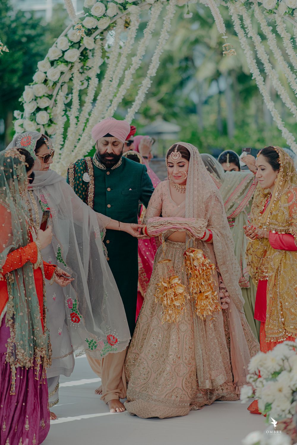 Photo of A bride entering for her Anand Karaj, along with her father