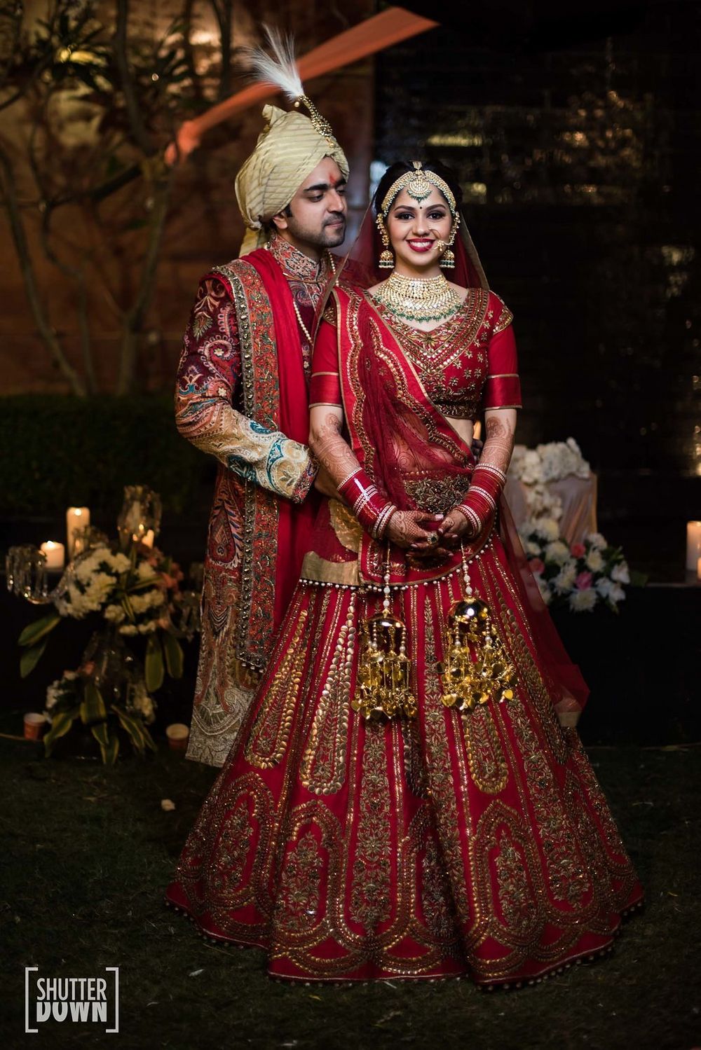 Photo of Matching bride and groom in red outfits