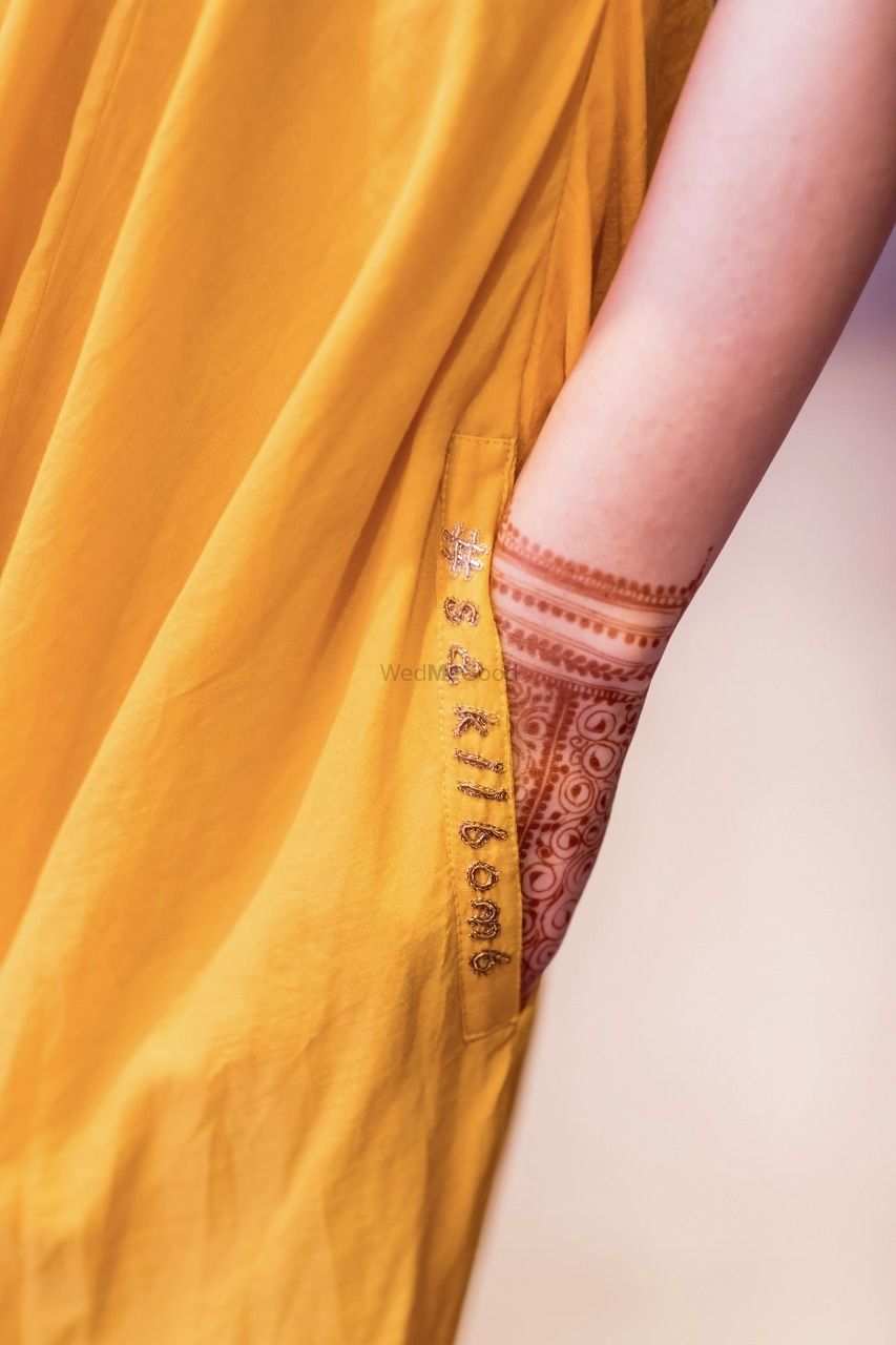 Photo of Bridal mehendi outfit with embroidered wedding hashtag
