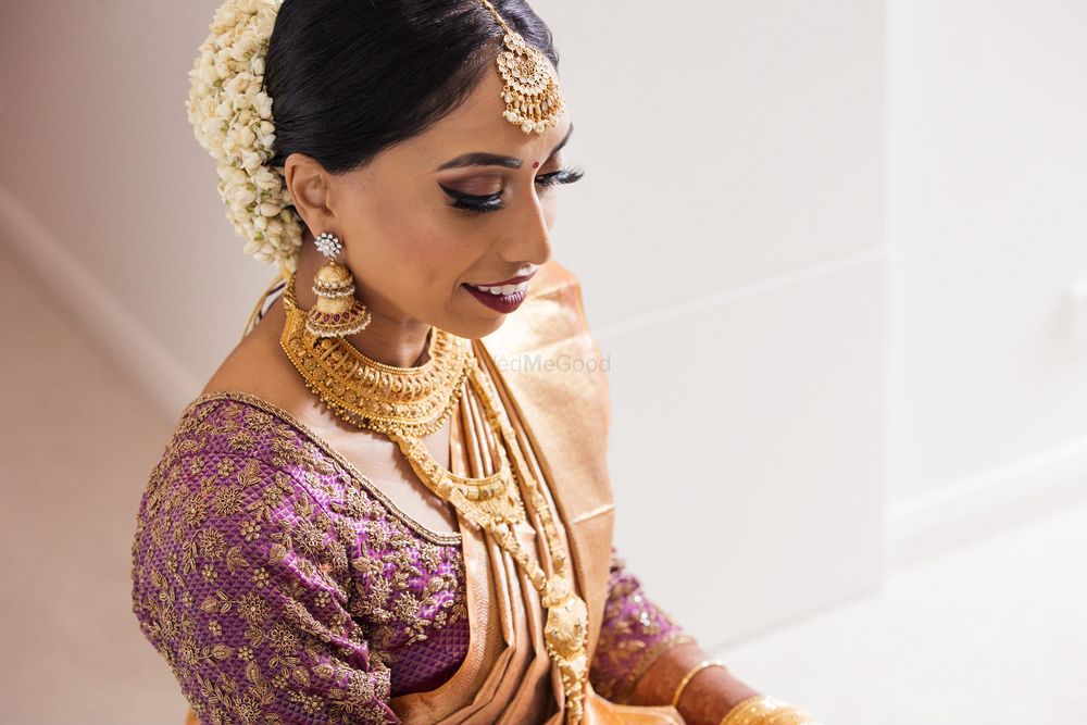 Photo of south indian bride with gold saree and purple blouse