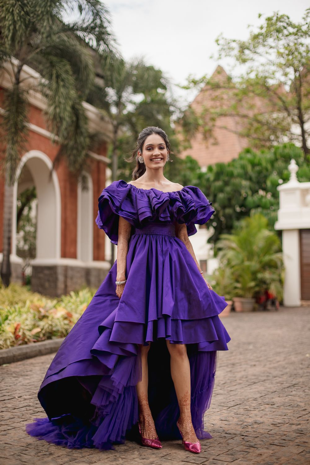 Photo of Bride posing in a vibrant purple dress for her day event by the beach - Carnival