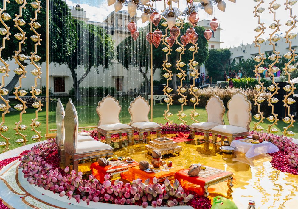Photo of Stunning mandap decor for an outdoor wedding with lotus buds, unique props and floral elements