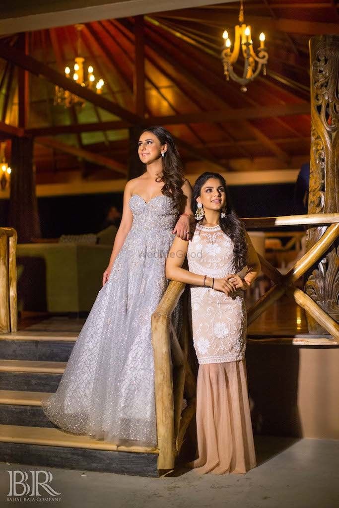 Photo of Bride with sister wearing cocktail gown