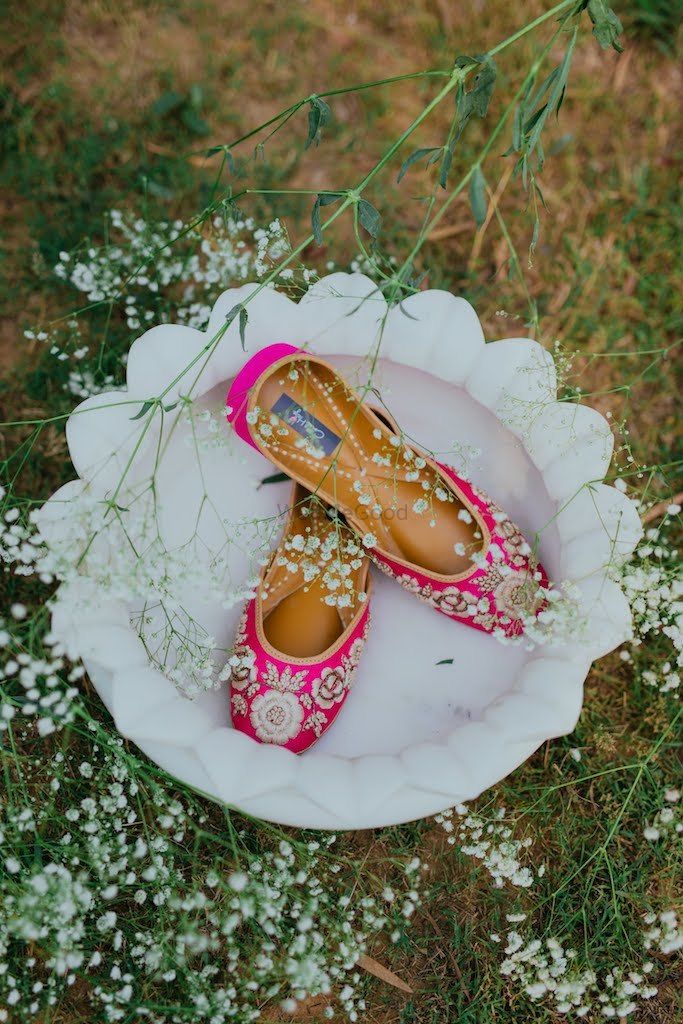 Photo of Pink bridal juttis with floral embroidery