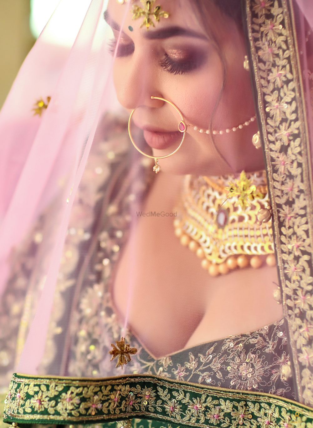 Photo of bridal portrait with veil and deep neck blouse
