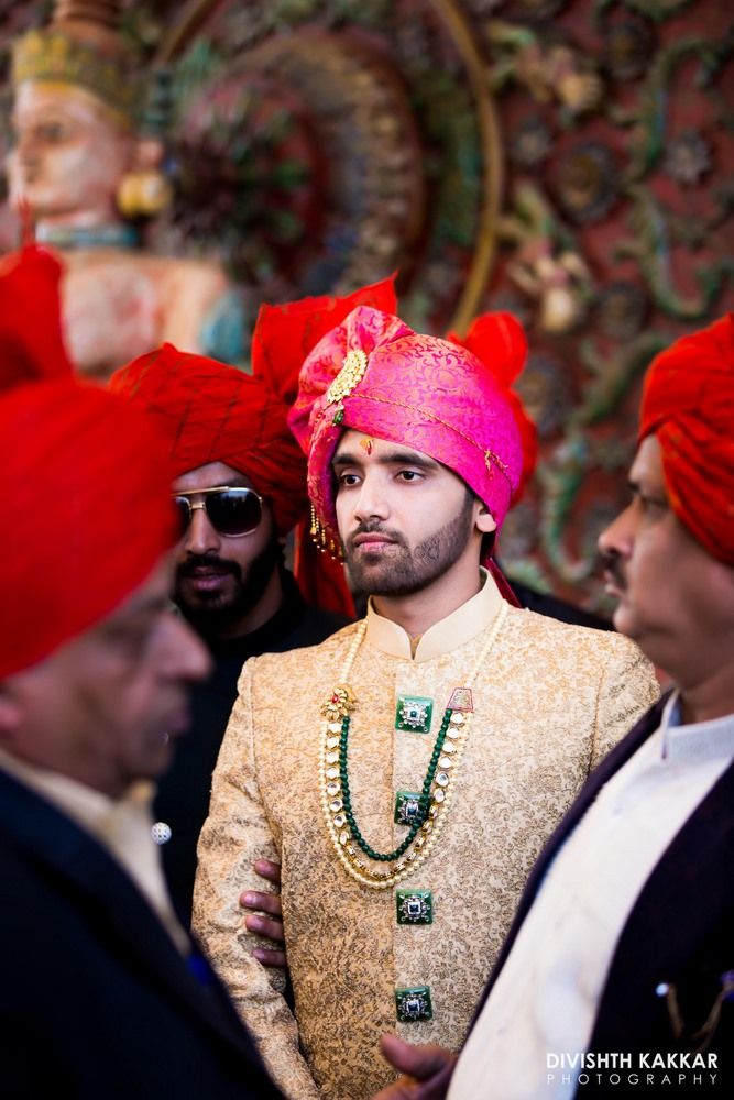 Photo of Beige and gold groom sherwani with green buttons