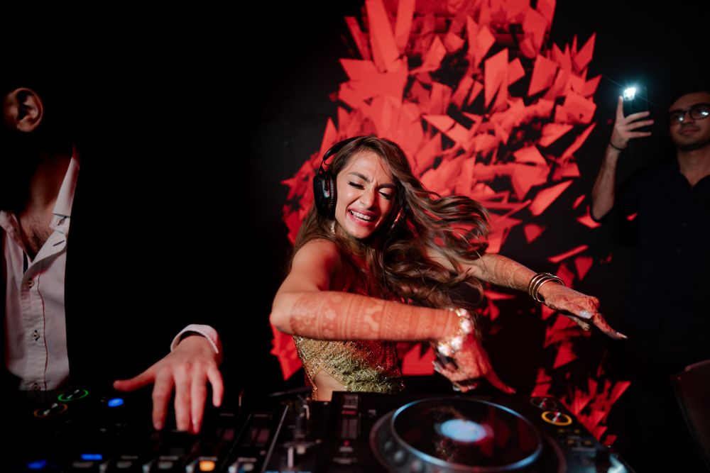 Photo of This funky bridal shot of the bride playing the DJ at her cocktail event