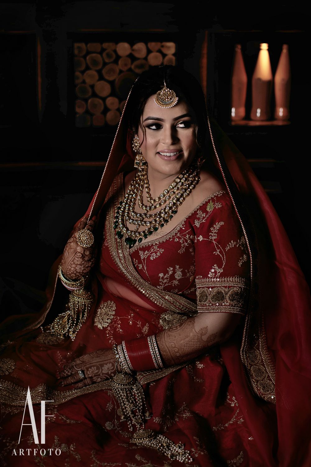 Photo of Bride wearing red sabyasachi lehenga with zardozi work
