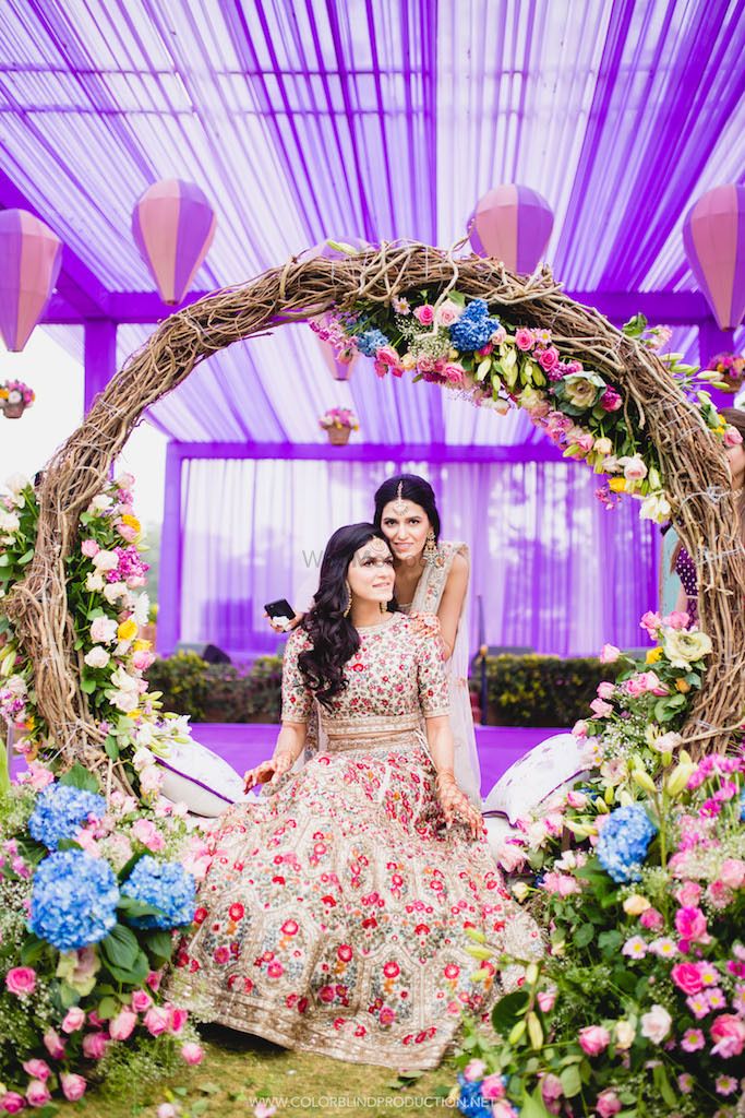 Photo of Bride with sister with gorgeous mehendi decor