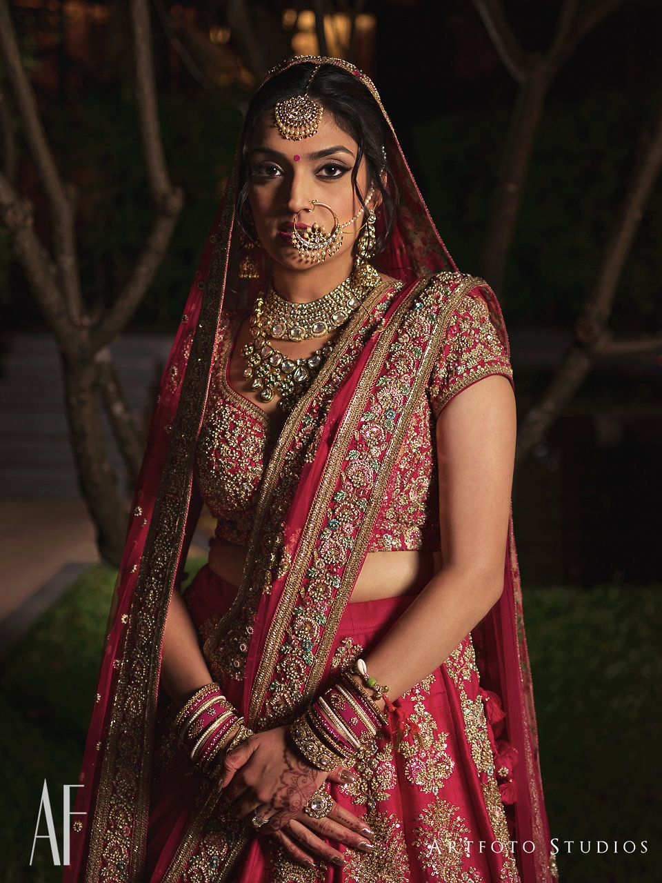 Photo of Bride looking regal in silver jewellery and red lehenga