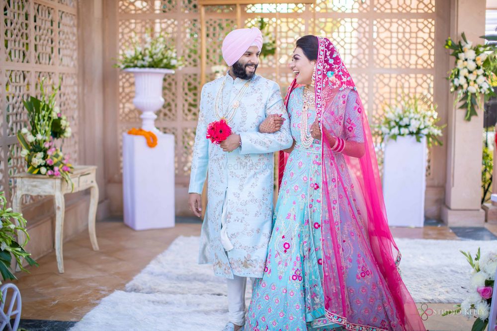 Photo of matching bride and groom in powder blue outfits