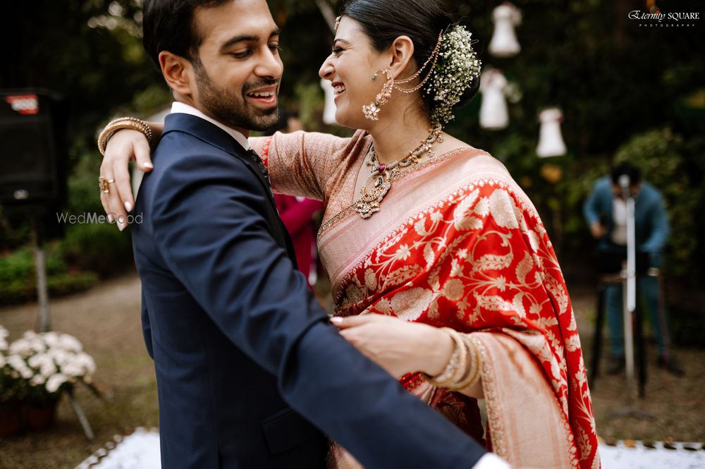 Photo of bridal bun with flowers and bride in red sabyasachi saree