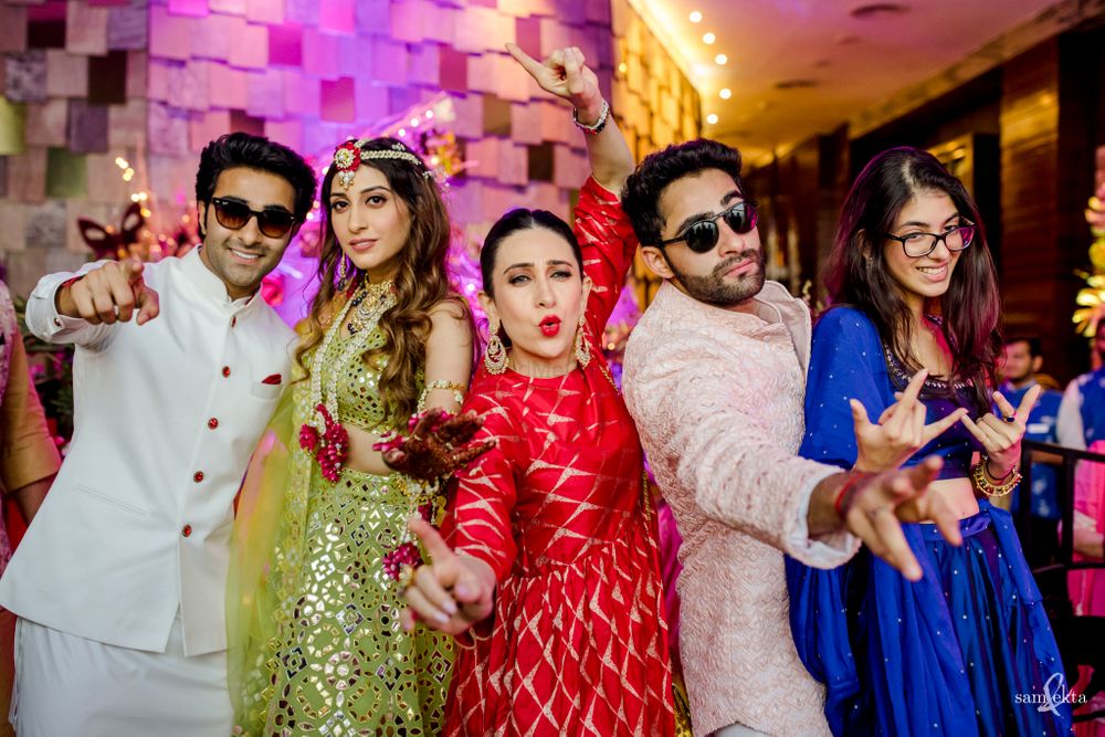 Photo of A dancing family portrait on mehendi day with karishma kapoor
