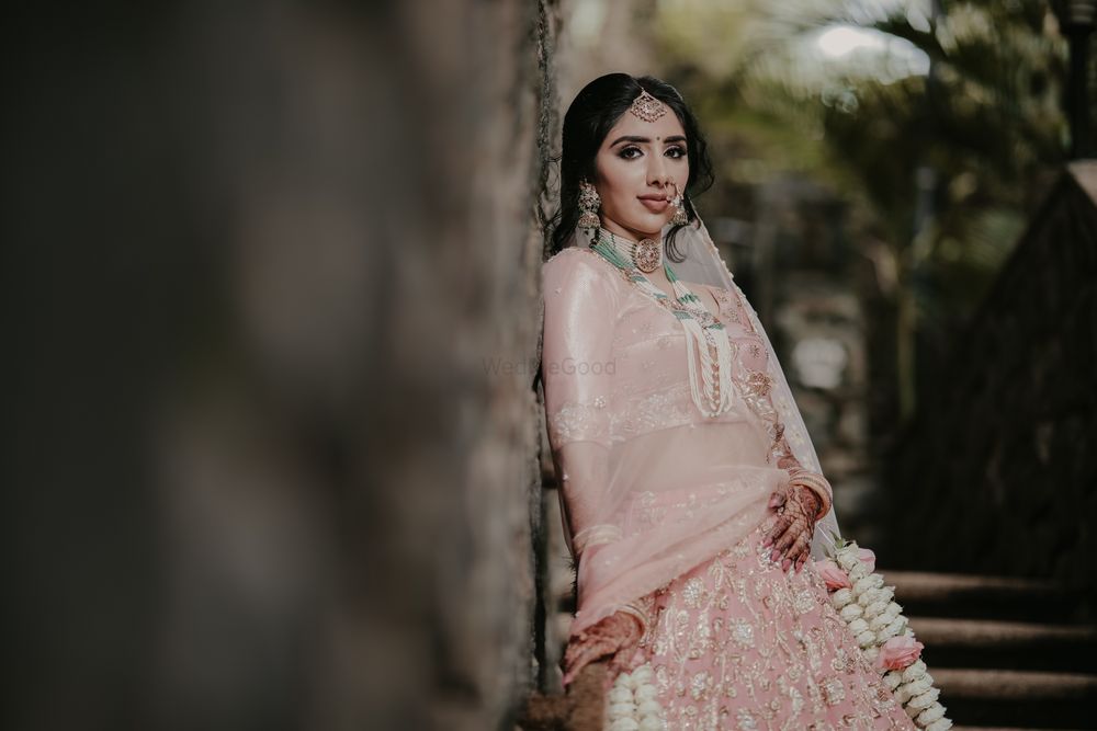 Photo of bridal portrait with floral kaleere and green jewellery with pastel lehenga