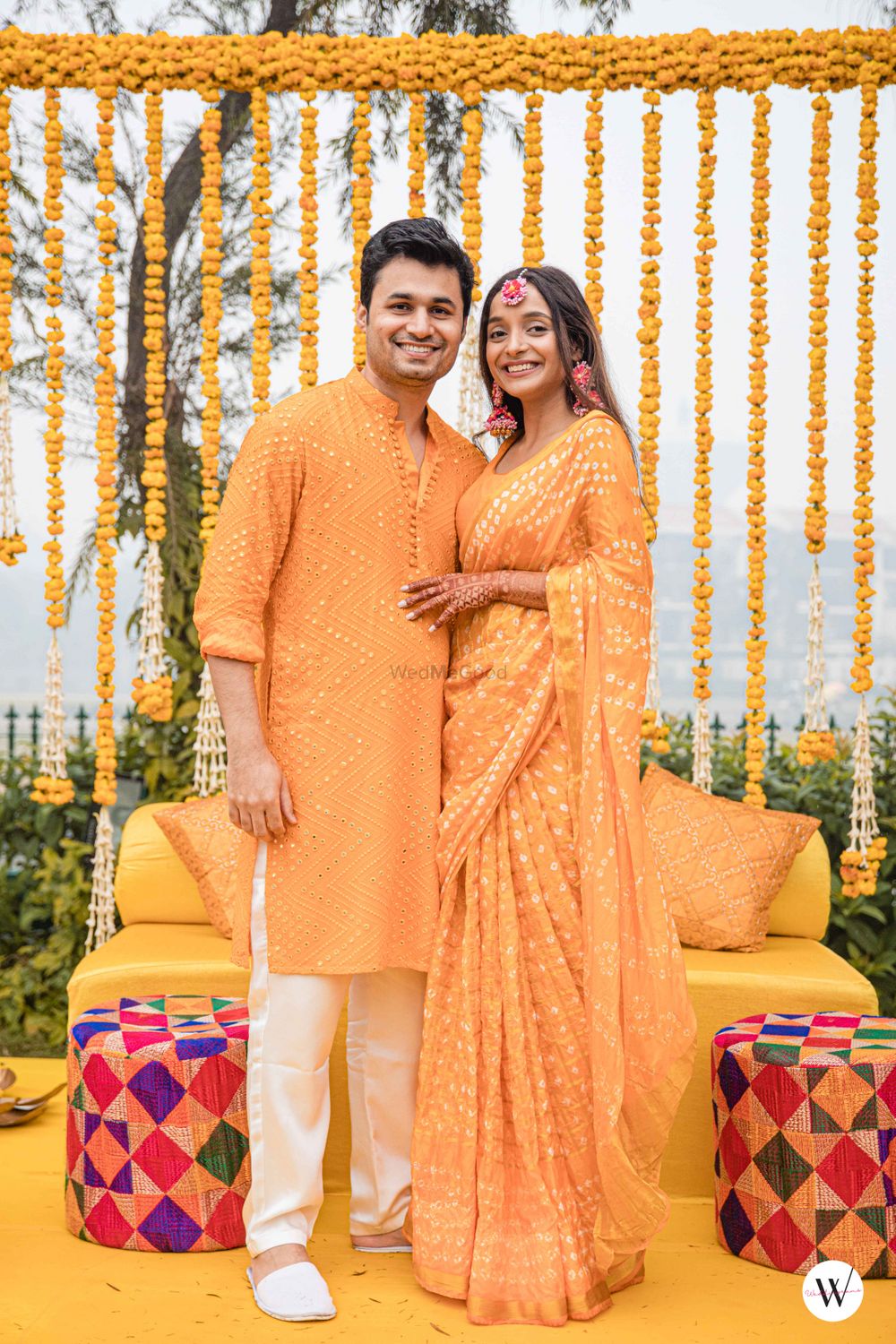 Photo of twinning bride and groom in yellow on haldi