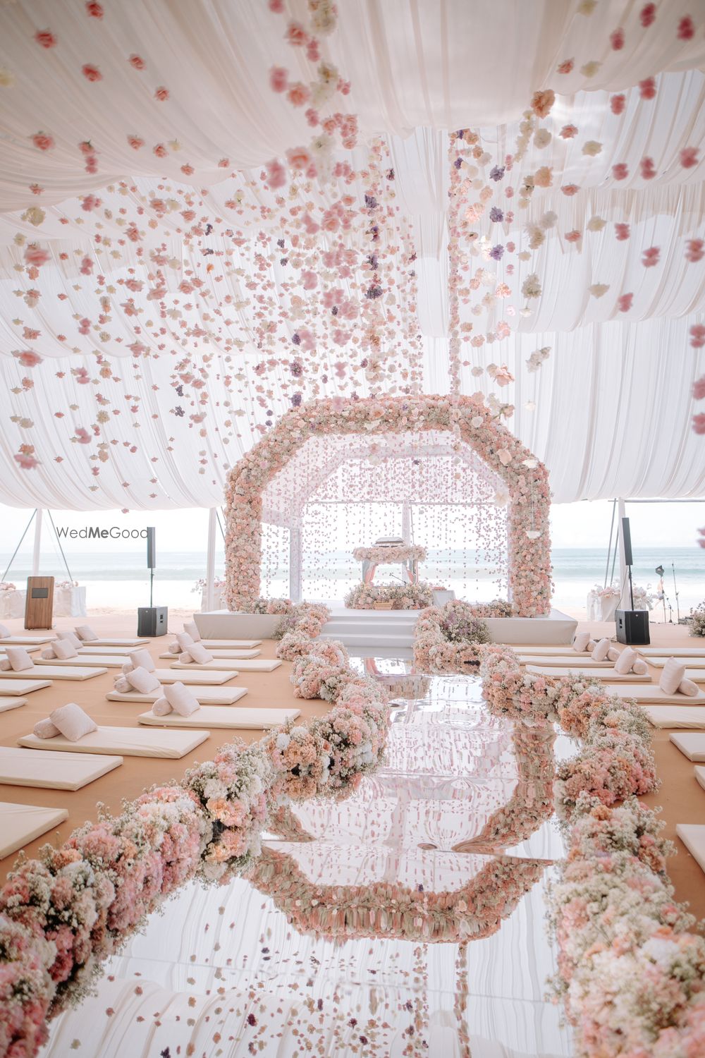 Photo of Gorgeous floral mandap in pink and white with a mirror aisle with hanging floral decor
