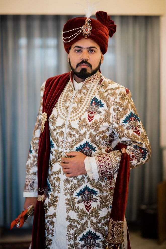 Photo of Ivory embroidered sherwani with a pop of blue