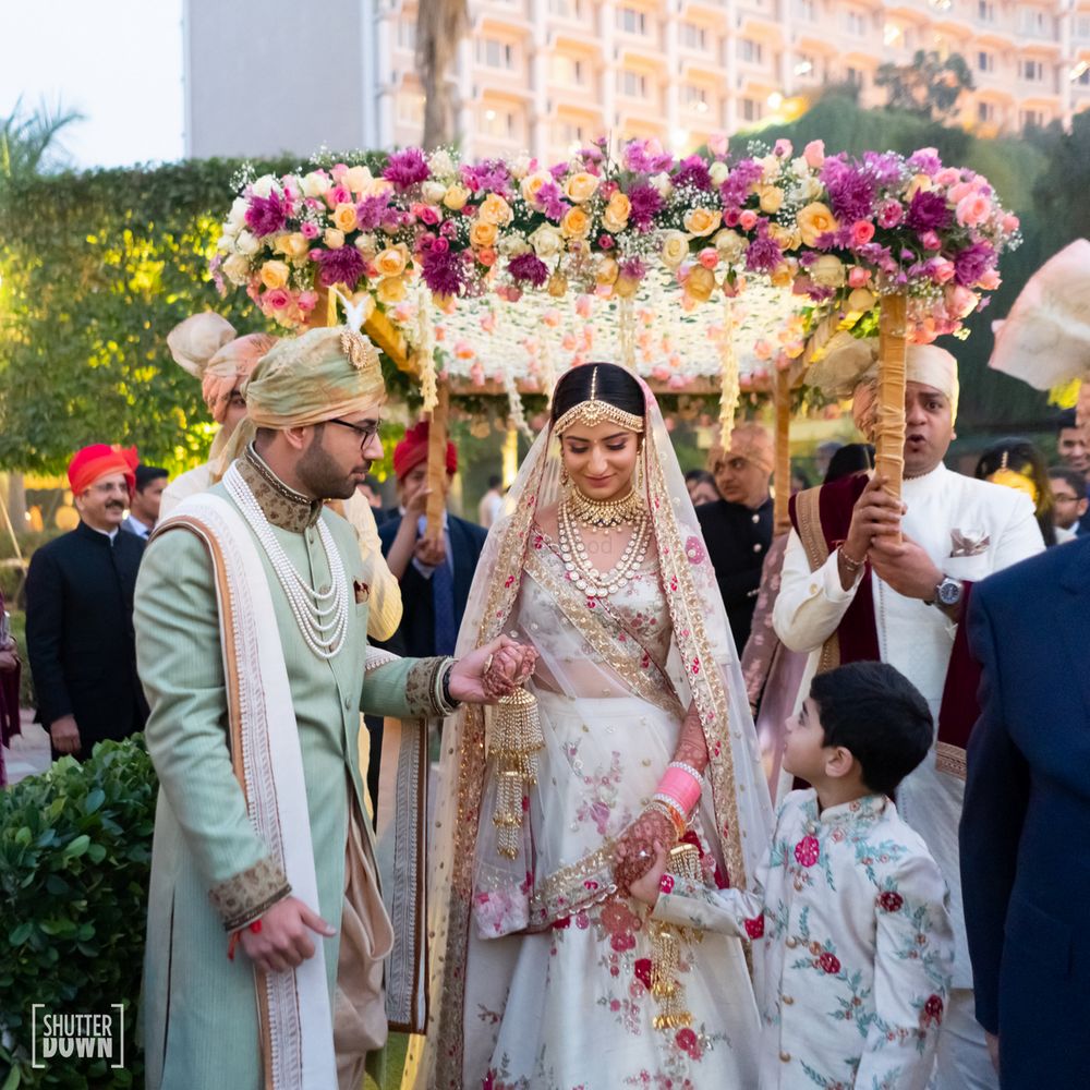 Photo of Bridal entry under phoolon ka chadar with multicolour flowers