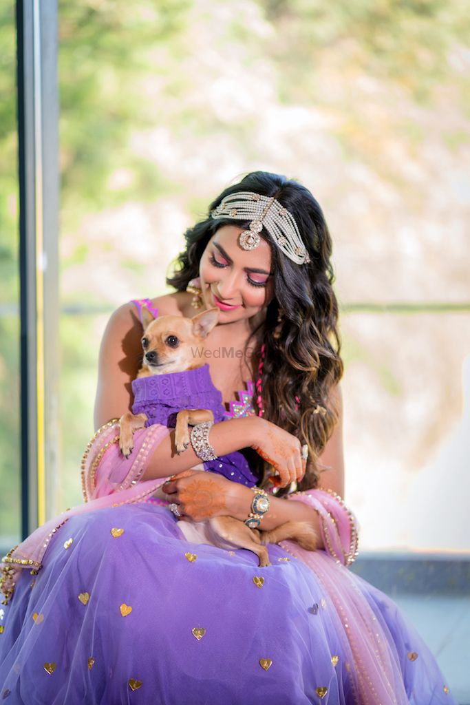 Photo of Cute bride with her dog for mehendi