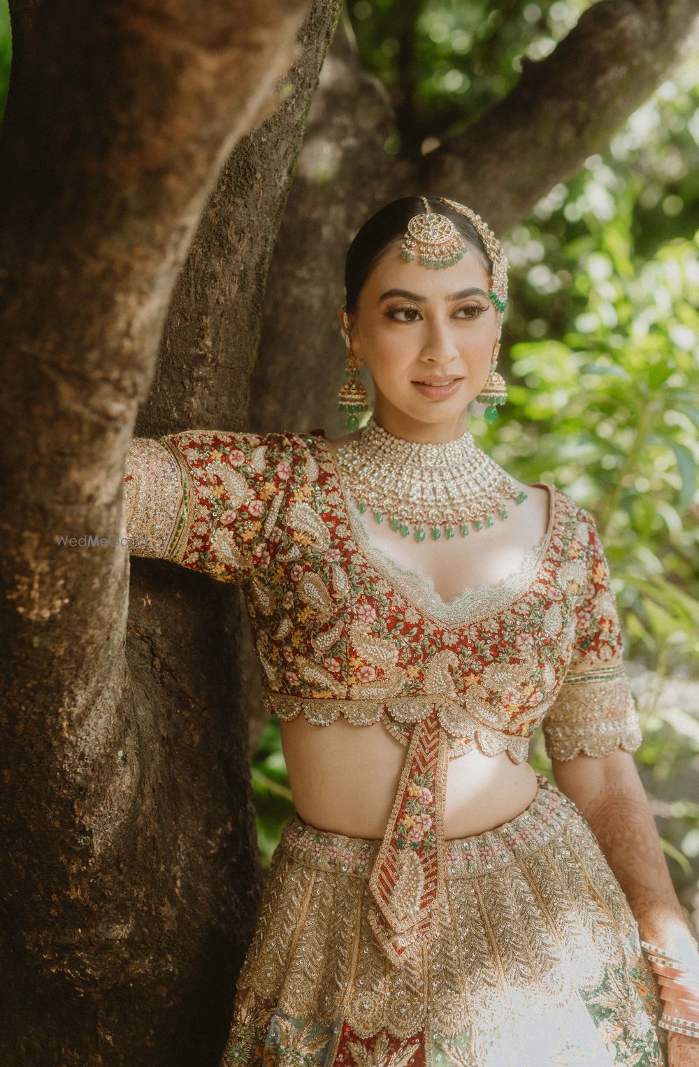 Photo of Heavy embroidered bridal blouse in red, green and gold with tie-detailing