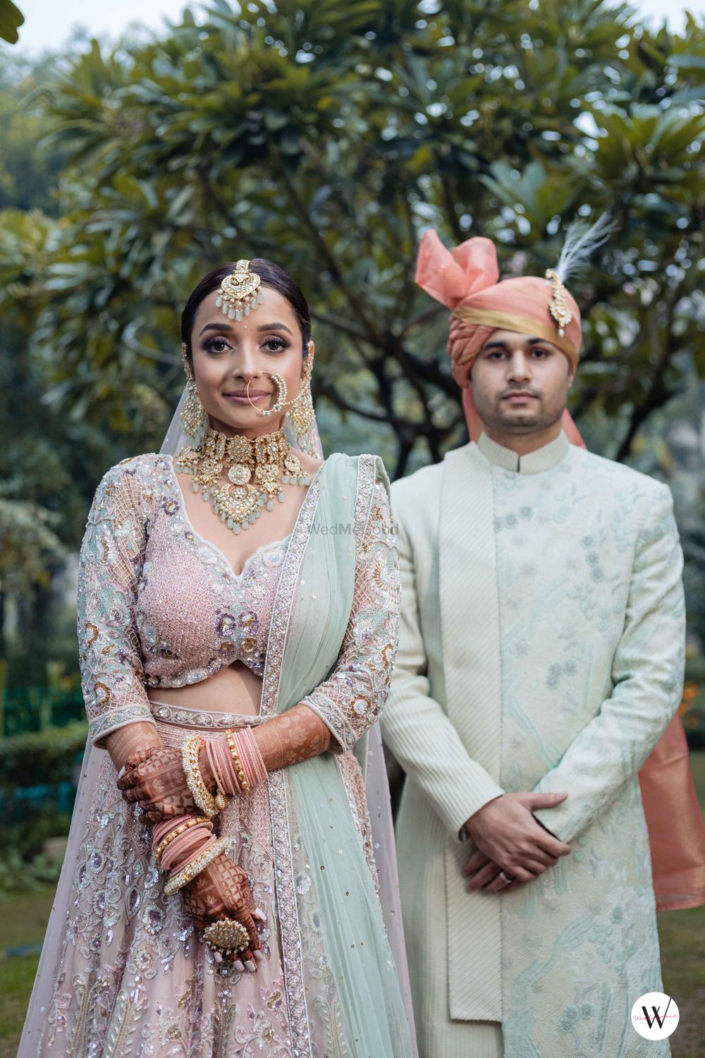 Photo of pastel bride and groom in contrasting outfits modern wedding look