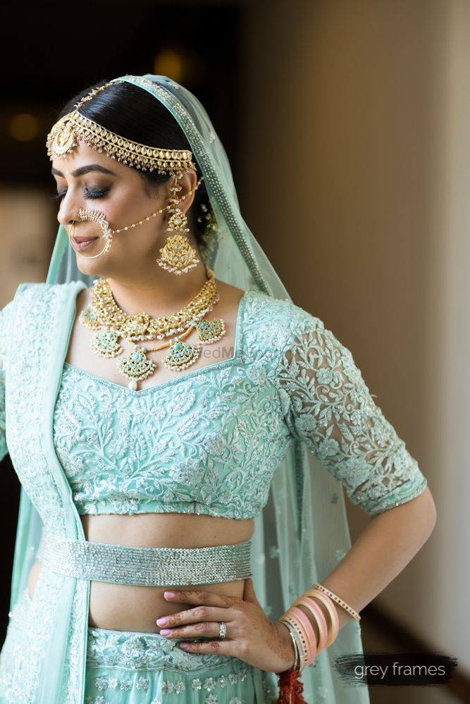 Photo of Beautiful bride in aqua blue lehenga with gold jewellery