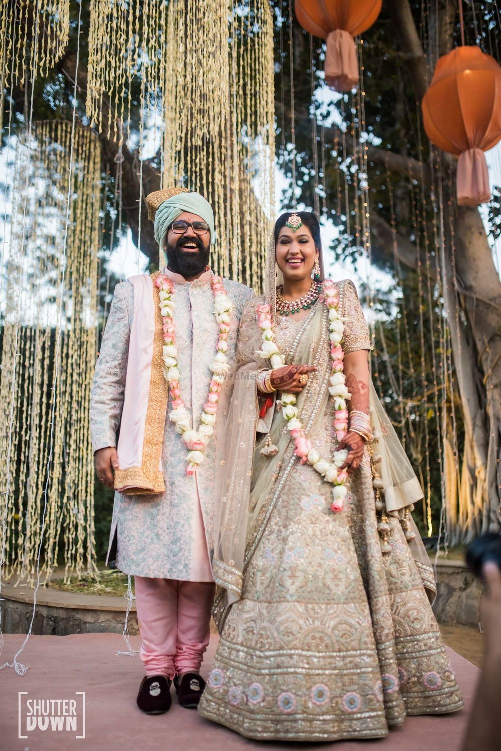 Photo of A bride and groom laugh as they clicked on their wedding day