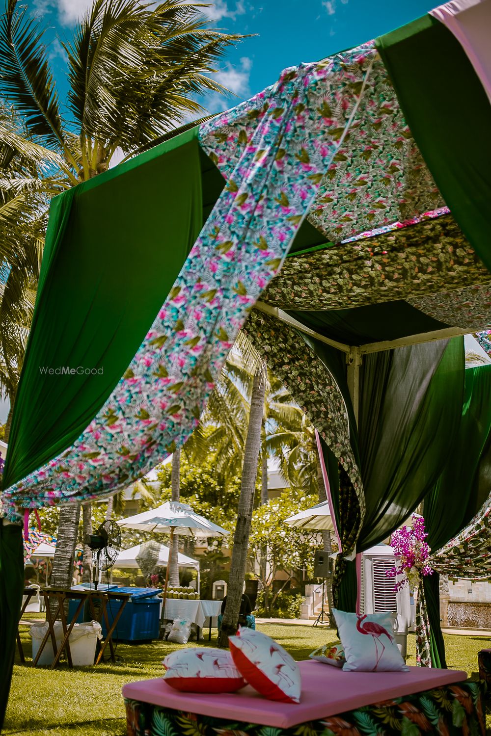 Photo of Tropical theme decor with floral drapes and flamingo cushions