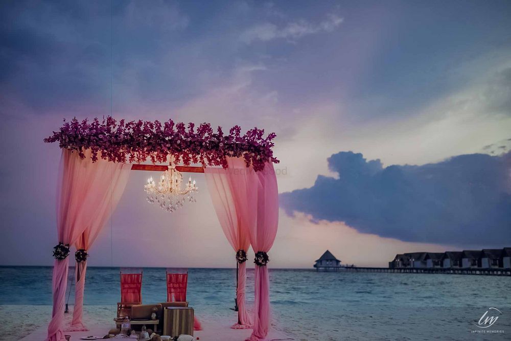 Photo of simple pink mandap idea by the beach